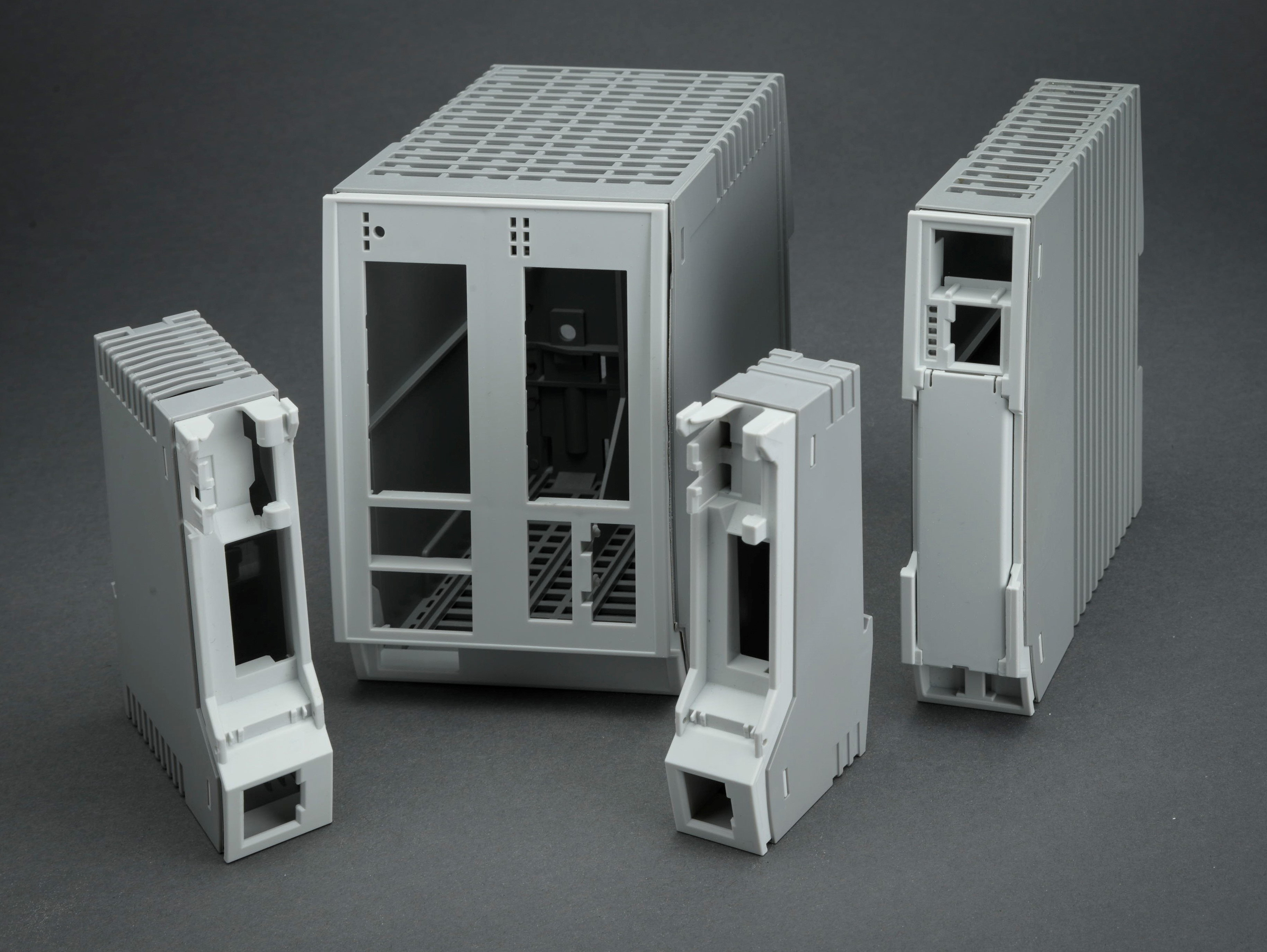 Four gray plastic housings standing next to each other