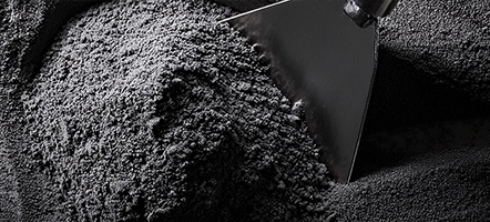 Dark gray plastic powder with metal trowel